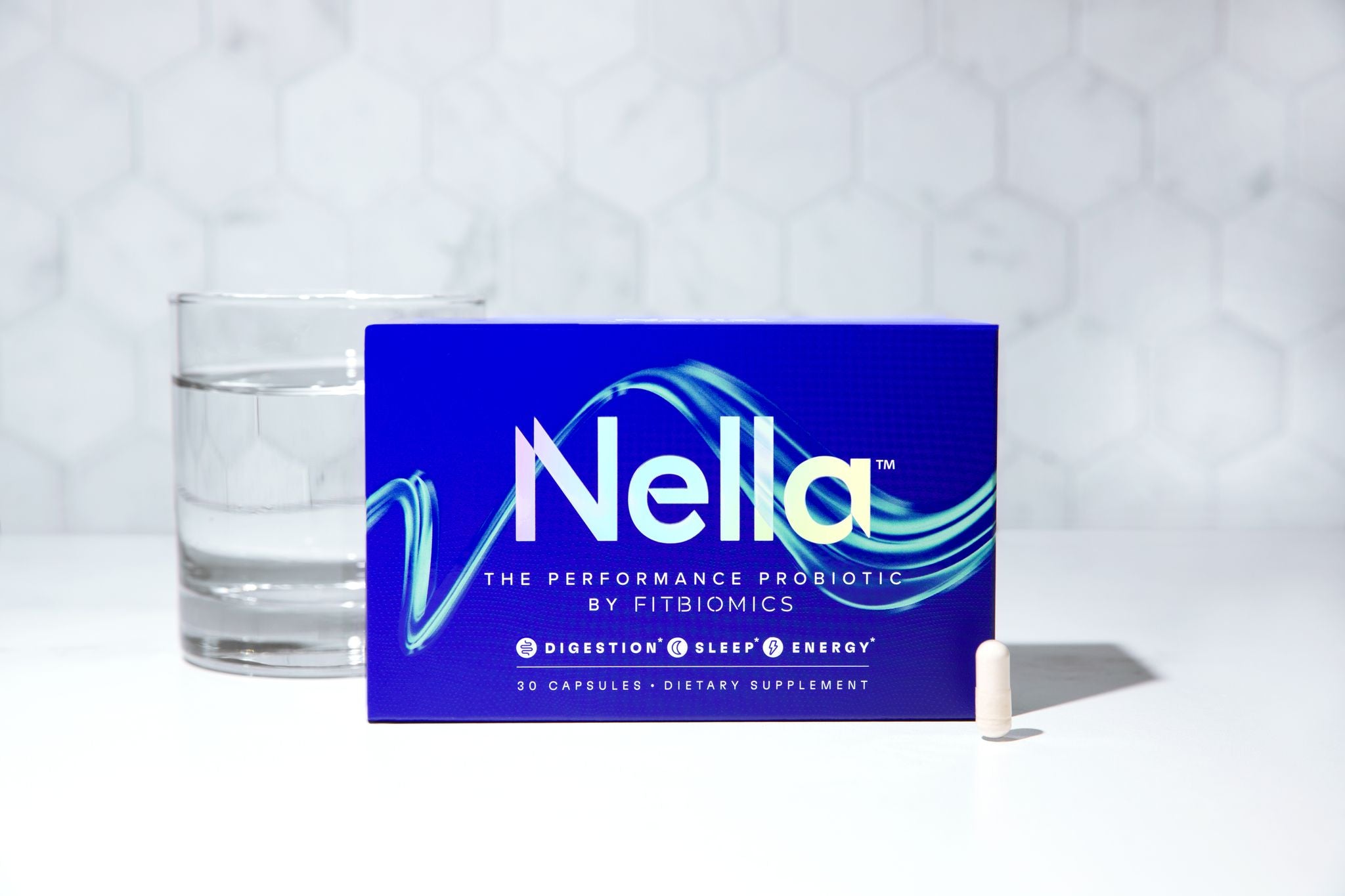 nella with a capsule and glass of water