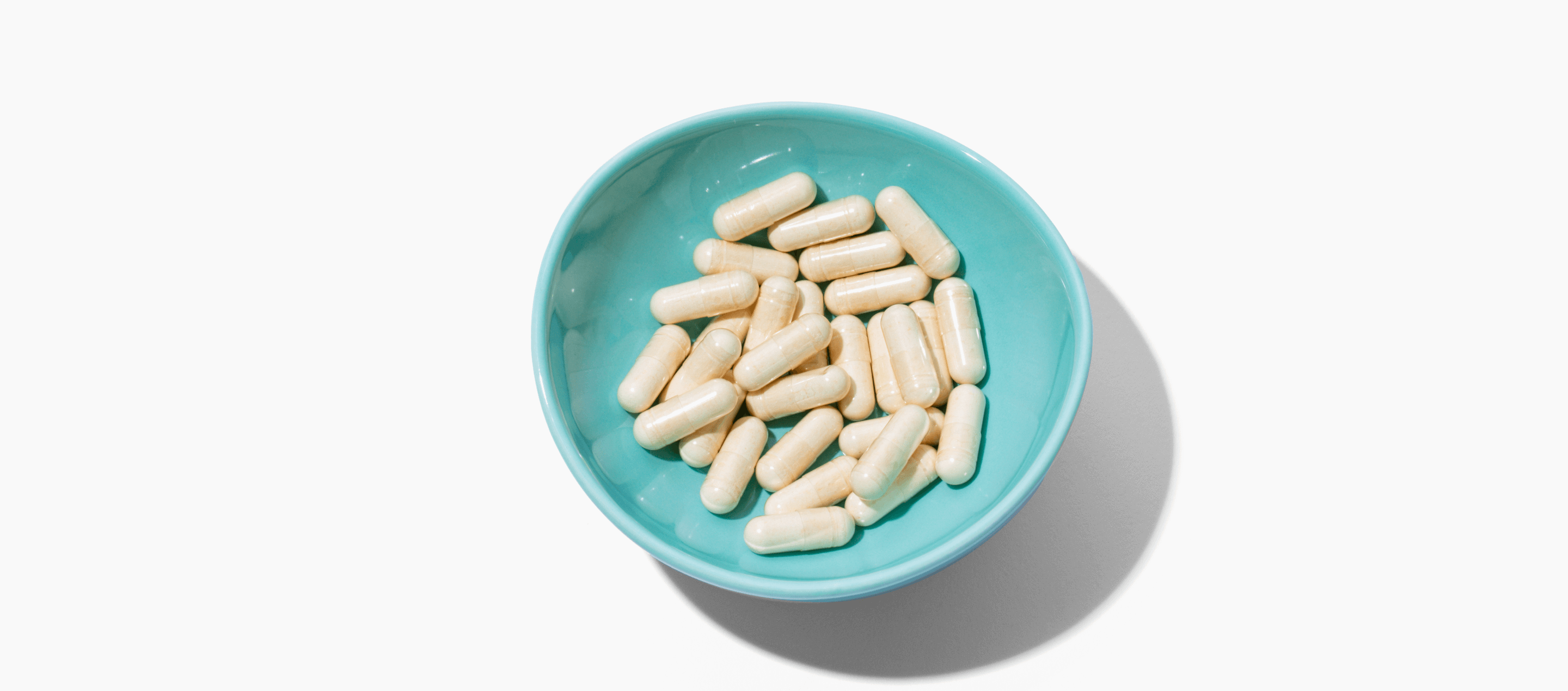 Blue ceramic dish with NELLA capsules